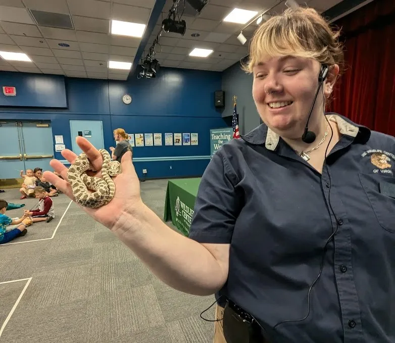 A WCV holds a snake up to the camera.