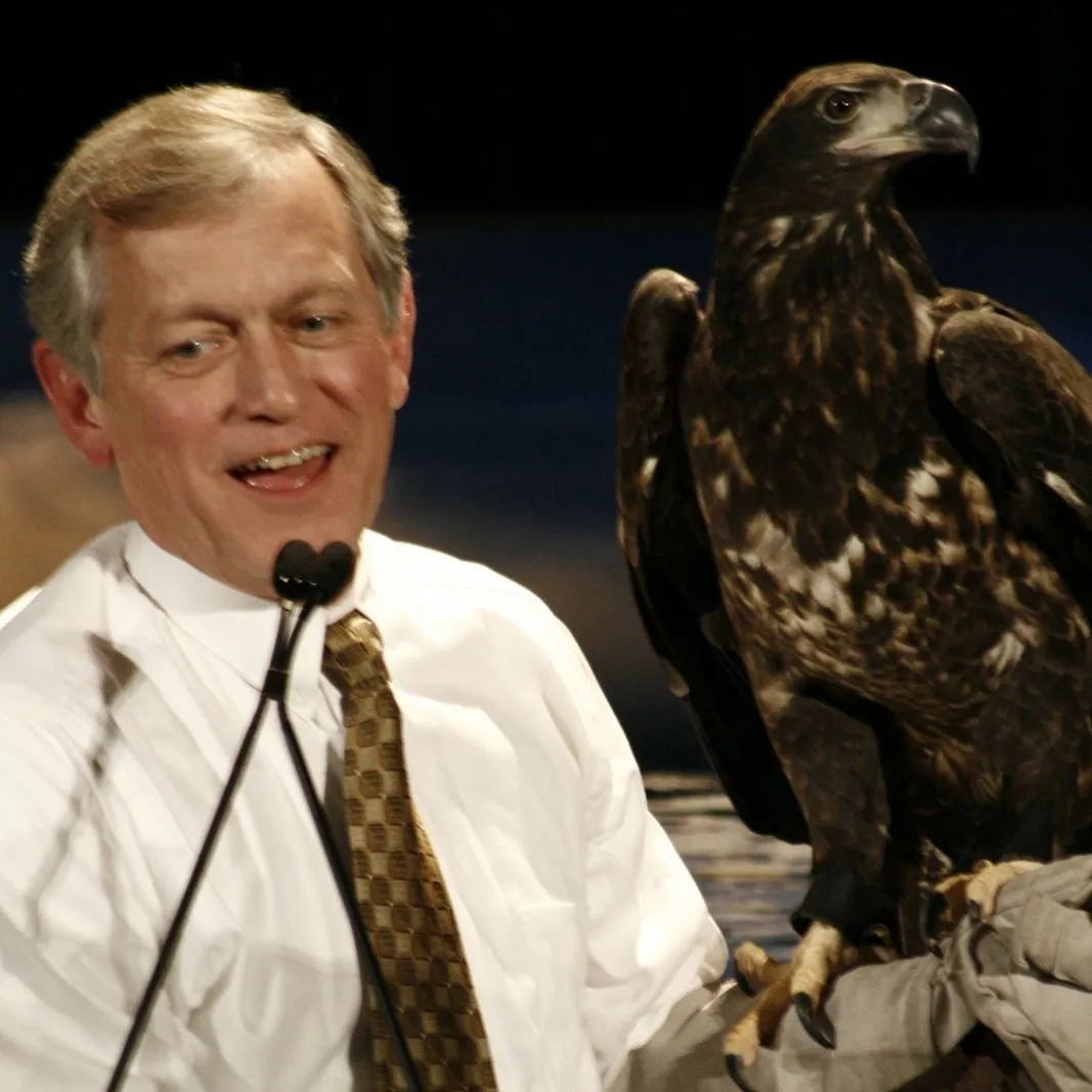 Wildlife Center President Ed Clark at the awards ceremony with a juvenile Bald Eagle