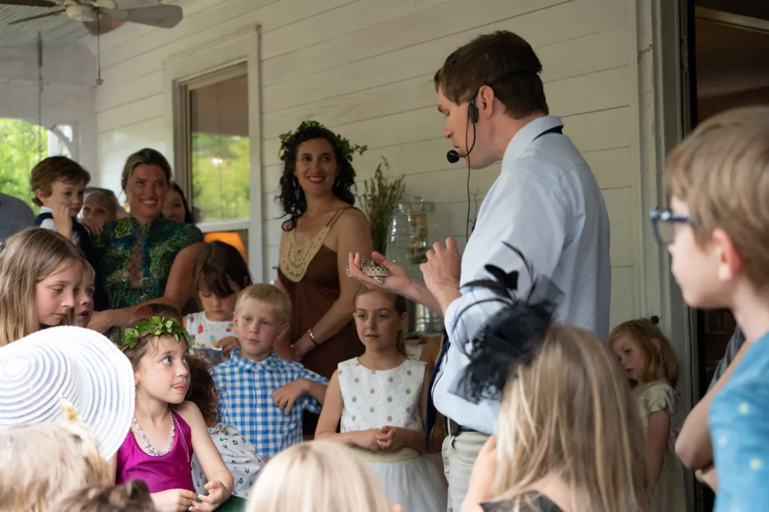 children gathered around opossum